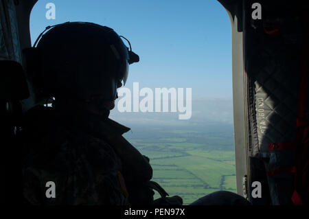 David Uplinger 1-228th Aviation Regiment flight engineer watches the landscape slip by the door of a U.S. Army CH-47 Chinook Dec. 17, 2015, as the aircraft flies over the Gracias a Dios Department (state) of Honduras. The aircraft provided airlift for Honduran troops to help support a request for assistance from the Honduran president in October 2014, to help disrupt the flow of drugs in the region. (U.S. Air Force photo by Capt. Christopher Mesnard/Released) Stock Photo