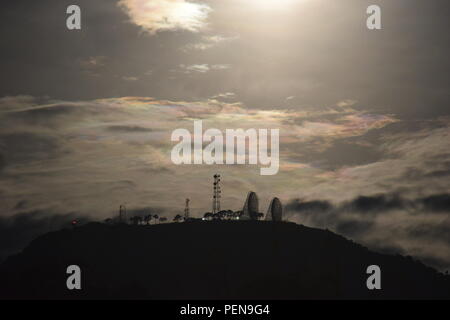 Moon setting behind communication and broadcasting equipments mounted on the summit of Mount Sto Tomas in Tuba, Benguet, Philippines Stock Photo