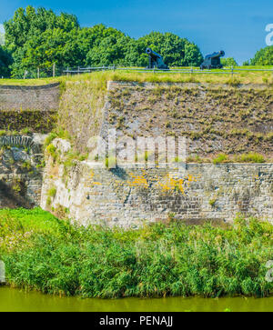 massive old stone defense wall with cannons Stock Photo