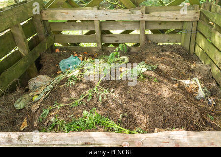 rotting compost in a bin made of wooden pallets. Stock Photo