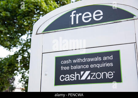 A sign indicating free cash withdrawls on a converted telephone box in a city centre street Preston Lancashire June 2018 Stock Photo