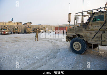 Sgt. Oumarou Pafadnam, a Soldiers with 317th Brigade Engineer Batallion, 3rd Brigade Combat Team, 10th Mountain Division (Light Infantry), Fort Polk, La., guides a Mine Resistant Ambush Protected vehicle back into staging position after a regular maintenance check, Bagram Air Field, Afghanistan, Jan. 12, 2016. Pafadnam, a Newark, N.J., native, works with Task Force Buffalo at Bagram Air Field, which provides force protection operations around the Airfield. Stock Photo