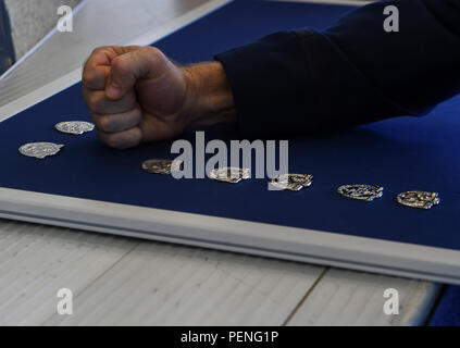 A fellow Special Tactics Airman pounds his beret flash into a board following a memorial ceremony for Capt. Matthew D. Roland and Staff Sgt. Forrest B. Sibley, at Hurlburt Field, Fla., Aug. 7, 2015. More than 1000 friends and family members from across the country gathered together to mourn the loss of Capt. Matthew Roland, a special tactics officer from 23rd Special Tactics Squadron, and Staff Sgt. Forrest Sibley, a combat controller from the 21st Special Tactics Squadron, at the Freedom Hangar on Hurlburt Field, Fla., Sep. 14, 2015. The two Special Tactics Airmen, who had recently deployed t Stock Photo