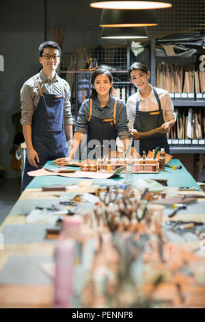 Portrait of confident leather craftspeople in studio Stock Photo