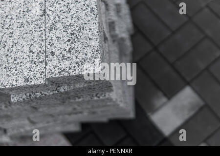 pavement cobblestone in the stack on the street. Concrete or granite gray square pavement slabs for sidewalk construction. Industry manufacturing or building concept. Construction material Stock Photo