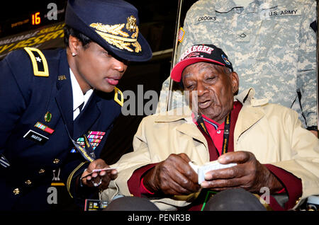 Brig. Gen. Donna Martin (left), deputy commanding general of operations of U.S. Army Recruiting Command, listens to stories and looks at pictures from Theodore Johnson, one of few surviving Tuskegee Airmen, during the pre-game ceremonies of the 2016 All-American Bowl, Jan. 9. Johnson was introduced to a loud ovation at the 50-yard line prior to the opening kickoff. The AAB is U.S. Army sponsored bowl game that features the top 90 high school football players in the Nation. Current NFL players who participated in AAB in past years include, Andrew Luck, Adrian Peterson, and Odell Beckham Jr. Stock Photo