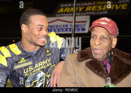 Cameron Chambers (left), East Team player for the 2016 All-American Bowl, and Dr. Granville Coggs (right), a surviving Tuskegee Airmen, meet before the 2016 All-American Bowl, Jan. 9. Chambers great uncle Wesley C. Walker was a Tuskegee Airmen who entered the Lonely Eagle Chapter in 2005 at the age of 85. During the pregame ceremonies, Coggs and fellow Tuskegee Airmen, Theodore Johnson, were introduced to the crowd at midfield. The AAB is U.S. Army sponsored bowl game that features the top 90 high school football players in the Nation. Stock Photo