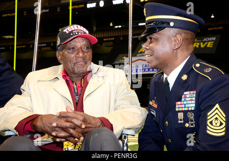 Theodore Johnson (left), one of few surviving Tuskegee Airmen, speaks with Command Sgt. Maj. Willie Clemmons (right), command sergeant major of the U.S. Army Recruiting Command, during the pre-game ceremonies of the 2016 All-American Bowl, Jan. 9. Johnson was introduced to a loud ovation at the 50-yard line prior to the opening kickoff. The AAB is U.S. Army sponsored bowl game that features the top 90 high school football players in the Nation. Current NFL players who participated in AAB in past years include, Andrew Luck, Adrian Peterson, and Odell Beckham Jr. Stock Photo