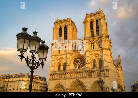 Setting sunlight on the front facade of Cathedral Notre Dame, Paris, France