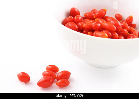 composition of fresh goji berries in a white bowl isolated on a white background Stock Photo