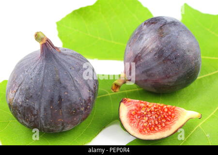 composition of fresh fig fruits on a fig leaf Stock Photo