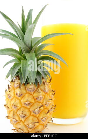 fresh pineapple and a glass of pineapple juice isolated in closeup view Stock Photo
