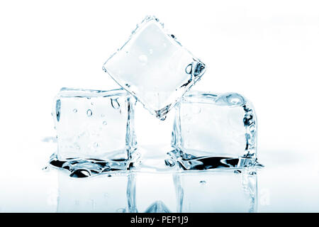 Three ice cubes melting isolated on white background. Stock Photo