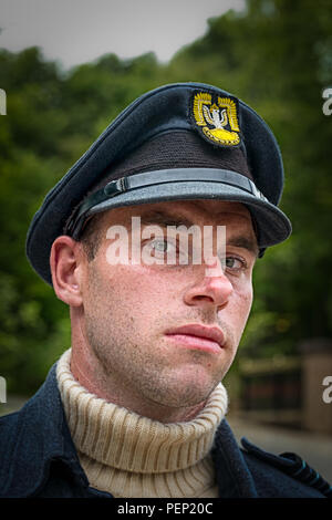 Close-up, front view portrait of wartime airman officer, Polish Air Force in white poloneck sweater & peaked cap, Crich Tramway Village 1940's event. Stock Photo
