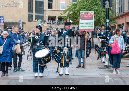 Glasgow, Scotland, UK. 16th August, 2018. Members of The Pipers’ Trail a collective from the Royal Edinburgh Military Tattoo performing in Buchanan Street during Piping Live. Credit: Skully/Alamy Live News Stock Photo