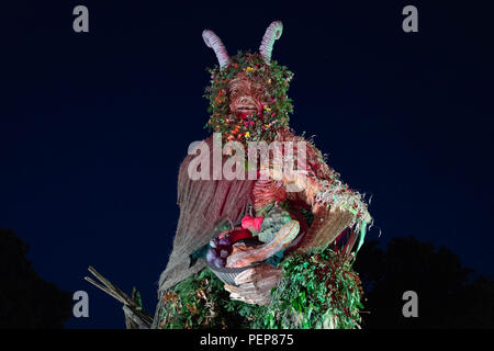 Glanusk Park, Brecon, Wales, 16th August 2018.  The first evening of the Green Man music festival in the Brecon Beacons Mountains in Wales. The site is opened the day before the festival proper. The huge Wicker Green Man sculpture is always one of the most popular areas. Credit: Rob Watkins/Alamy Live News Stock Photo