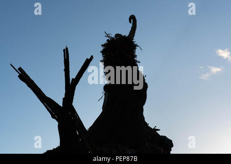 Glanusk Park, Brecon, Wales, 16th August 2018.  The first evening of the Green Man music festival in the Brecon Beacons Mountains in Wales. The site is opened the day before the festival proper. Pictures: The huge Wicker Green Man sculpture is always one of the most popular areas. Credit: Rob Watkins/Alamy Live News Stock Photo