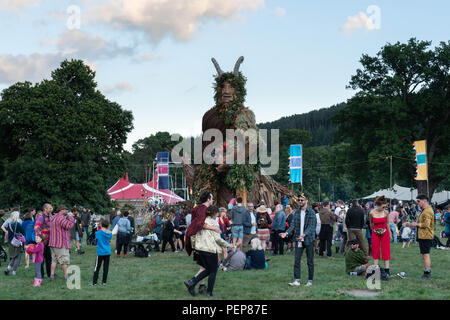 Glanusk Park, Brecon, Wales, 16th August 2018.  The first evening of the Green Man music festival in the Brecon Beacons Mountains in Wales. The site is opened the day before the festival proper. The huge Wicker Green Man sculpture is always one of the most popular areas. Credit: Rob Watkins/Alamy Live News Stock Photo