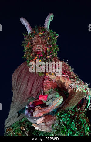 Glanusk Park, Brecon, Wales, 16th August 2018.  The first evening of the Green Man music festival in the Brecon Beacons Mountains in Wales. The site is opened the day before the festival proper. The huge Wicker Green Man sculpture is always one of the most popular areas. Credit: Rob Watkins/Alamy Live News Stock Photo