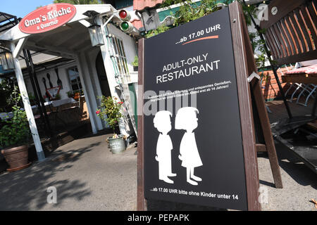 dpatop - 16 August 2018, Germany, Binz: A sign with the inscription 'Adult-Only Restaurant - from 5pm no children under 14' standing in front of the entrance of the restaurant 'Grandma's Kueche'. (about dpa 'Restaurant on Rügen does not let children in in the evening' from 17.08.2018) Photo: Stefan Sauer/dpa