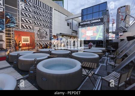 Tokyo, Japan. 17th Aug, 2018. Small inflatable water pools for Bathtub Cinema customers are seen on the rooftop of the revamped MAGNET by Shibuya109 building in Tokyo. Bathtub Cinema is held for the first time in Japan, which original concept is from London, people gathering to enjoy a movie and cool off on a outdoor bathing to escape from the high temperatures of this year that has sent thousands of people to the hospital for heatstroke. The event is held until August 19. Credit: Rodrigo Reyes Marin/ZUMA Wire/Alamy Live News Stock Photo