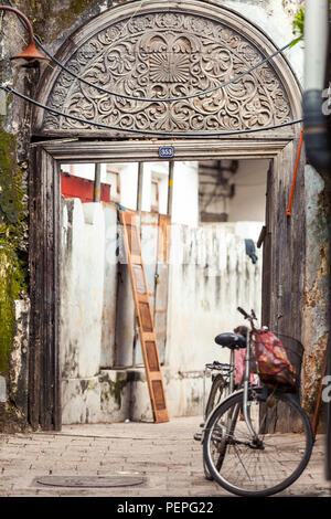 Stone Town, Zanzibar, 13 January - 2015: Old carved wooden door in alleyway. Stock Photo