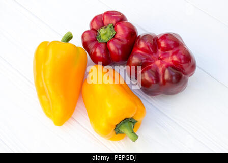 Red and yellow pepper on a white wooden background Stock Photo