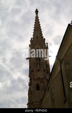 Unusual patterned dappled clouds in a lavender sky behind a church spire in Europe Stock Photo