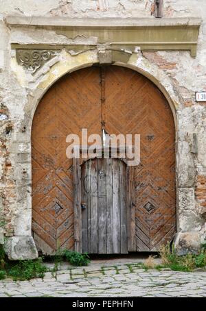 An old wooden door on a condemned building in Europe Stock Photo