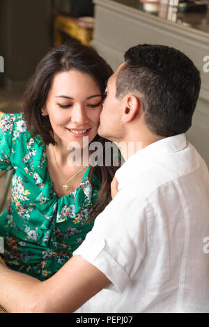 Attractive man kisses and hugs his beautiful wife Stock Photo