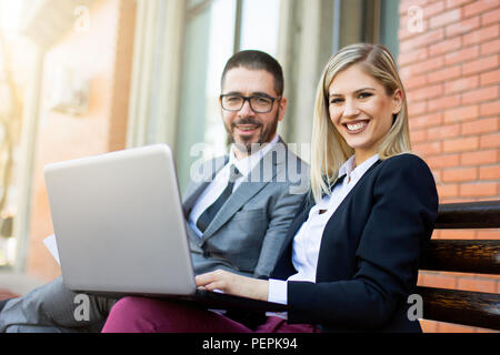 Businessman and bsuinesswoman working outdoor Stock Photo