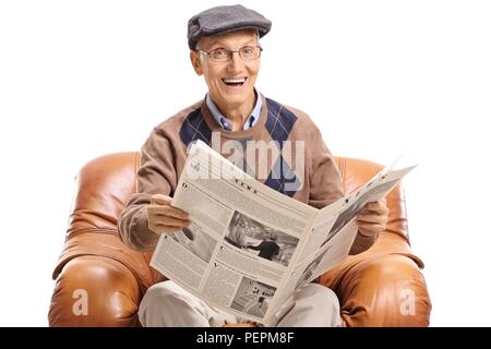 Elderly man with a newspaper sitting in a leather armchair isolated on white background Stock Photo