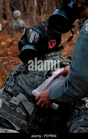 A U.S. Army Soldier, from the 73rd Transportation Floating Craft Company of the 19th Transportation Battalion, 7th Transportation Brigade (Expeditionary), performs Self-Aid Buddy Care on a fellow team member during a field training exercise at Fort A.P. Hill, Va., Jan. 12, 2016. The training was designed to teach the soldiers, who usually interact with watercraft and sea operations, how perform basic movements that are used in situations on land. (U.S. Air Force photo by Senior Airman Breonna Veal) Stock Photo