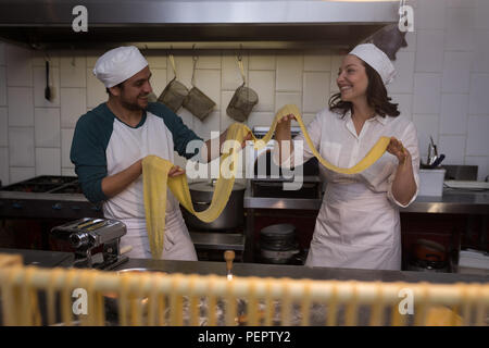 Bakers preparing pasta in bakery Stock Photo
