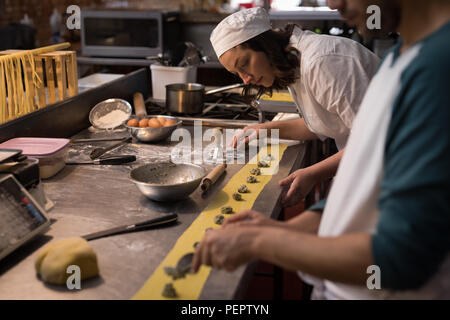 Bakers preparing pasta in bakery Stock Photo
