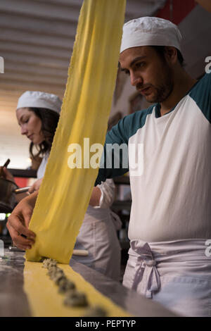 Bakers preparing pasta in bakery Stock Photo