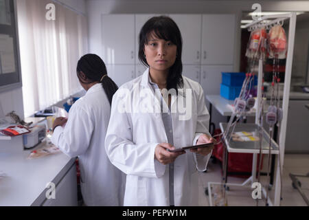 Laboratory technician using digital tablet Stock Photo