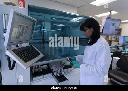 Laboratory technician using digital tablet Stock Photo