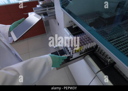 Laboratory technician analyzing blood samples Stock Photo