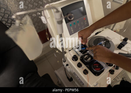 Laboratory technician using machine in blood bank Stock Photo