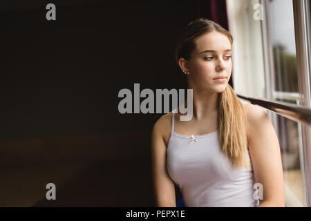 Ballerina looking through window Stock Photo