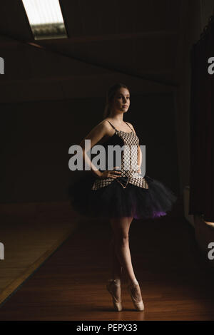 Ballerina standing en pointe in the ballet studio Stock Photo