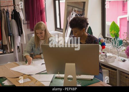 Fashion designers working on desk Stock Photo