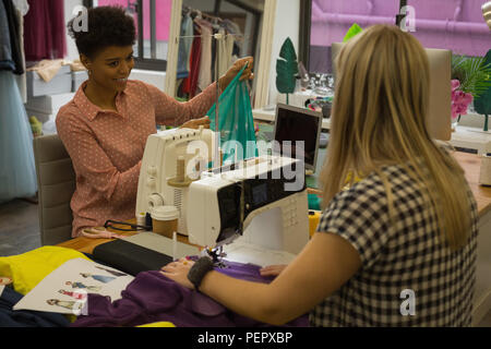 Fashion designers using sewing machine Stock Photo