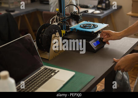 Mechanic using die machine on table Stock Photo