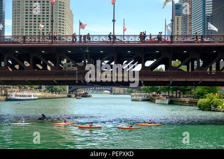 Kayaks on The Chicago River with DuSable Bridge (Michigan Ave) and surrounding downtown architecture in summer, Chicago, Illinois, USA Stock Photo