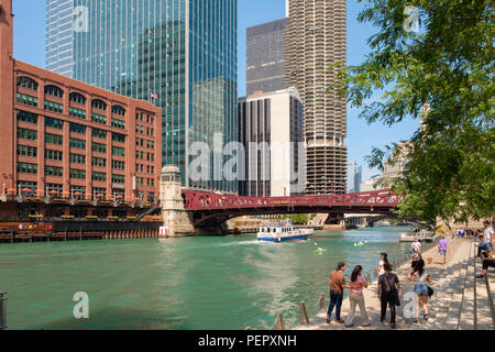 Chicago River and River Cruise with The Riverwalk and surrounding downtown architecture in summer, Chicago, Illinois, USA Stock Photo