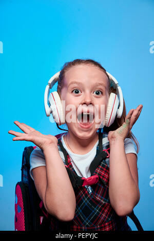 girl in school uniform with backpack Stock Photo