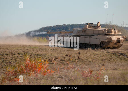 A tank crew from 2nd Battalion, 12th Cavalry Regiment, 1st Armored Brigade Combat Team, 1st Cavalry Division, fires their main gun at a target on Sugarloaf Range Dec. 3. Soldiers in the 1st ABCT have been training continuously to ensure everyone is qualified and prepared for the brigade’s nine-month deployment to South Korea in 2016. (U.S. Army photo by Sgt. Christopher Dennis, 1st Armored Brigade Combat Team Public Affairs, 1st Cav. Div.) Stock Photo