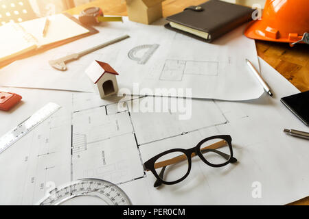A eyeglasses with architect house model and etc on architect desk Stock Photo